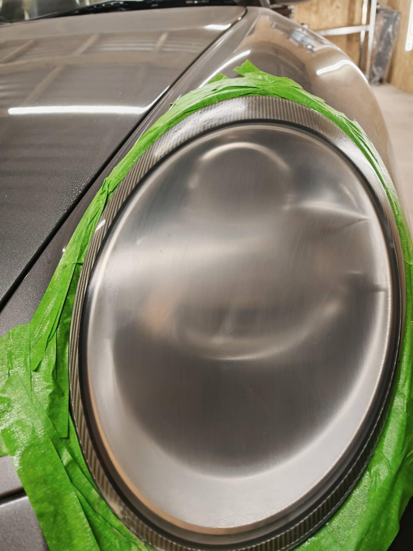 Porsche headlight sanded and masked mid-restoration by Tailored Detail